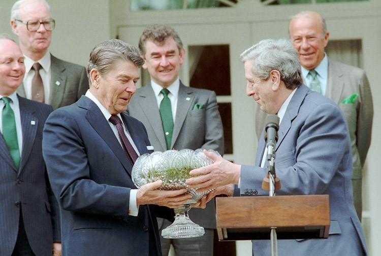 President Reagan receiving shamrocks in a Waterford crystal bowl from Prime Minister of Ireland Garret FitzGerald during a ceremony in the rose garden. 03/17/1986.
