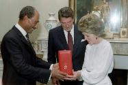 C3425-7, Egyptian President Anwar Sadat presents a gift, "Collar of the Nile " to President Rea…