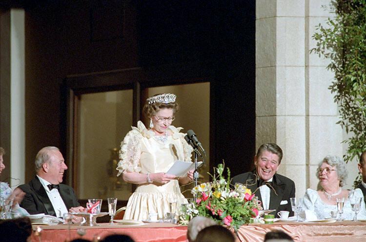 C13267-11, President Reagan laughing at remarks by Queen Elizabeth II at a dinner honoring her …