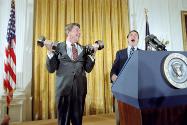 C6143-28, President Reagan lifting weights, with George Allen looking on, during a reception fo…