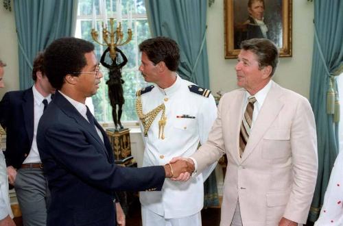 C9186-21, President Reagan shaking hands with Arthur Ashe at a White House Blue Room event for …