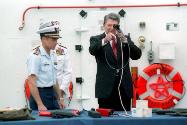 C47049-32, President Reagan looking through at camera lens aboard the U. S. Coast Guard Cutter …