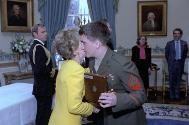 C326-3, Nancy Reagan hugging one of the freed American hostages at a White House private recept…