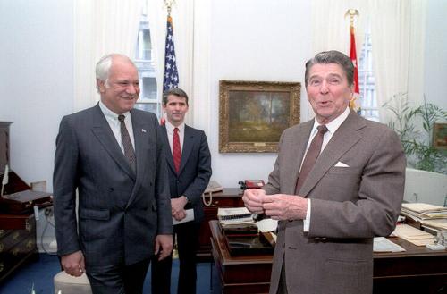 C28152-12, President Reagan in Robert McFarlane's office with Adolfo Calero, a Nicaraguan Democ…