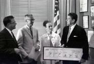 AVC2-2a Governor Ronald Reagan being presented with framed Peanuts cartoon comic strip during m…